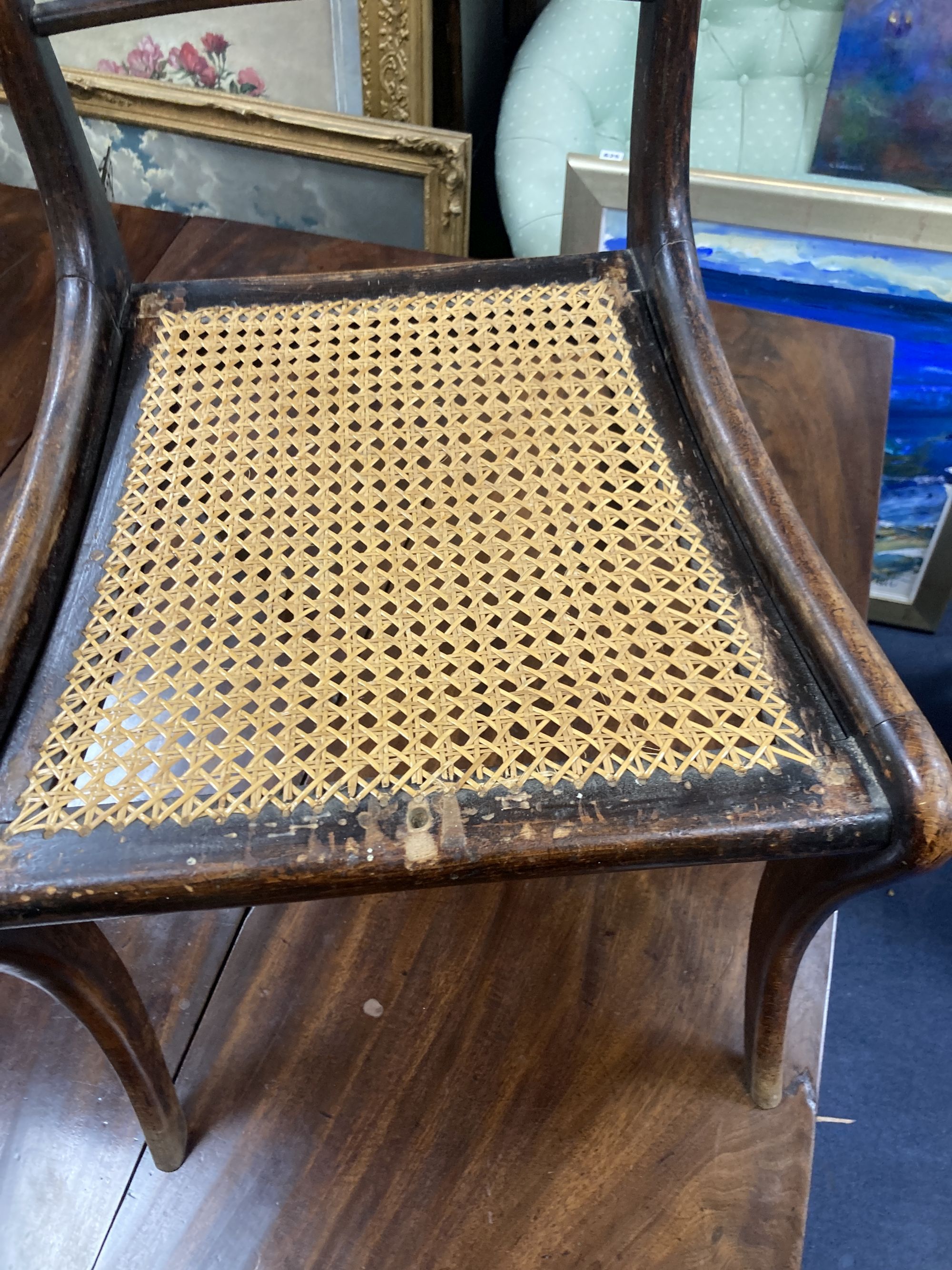 A set of five Regency brass inlaid simulated rosewood cane seated dining chairs